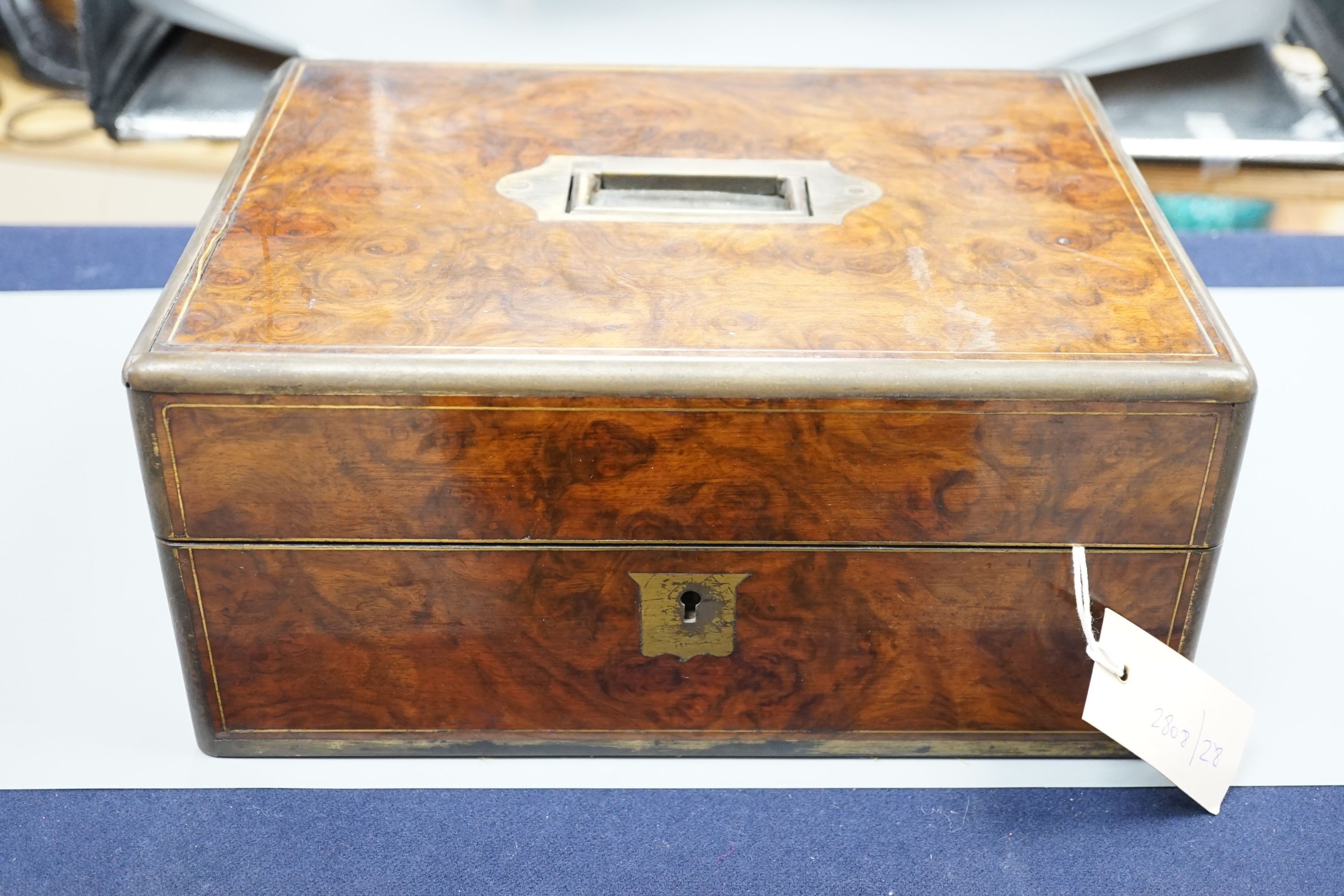 A Victorian brass mounted burr walnut toilet box, fitted with glass jars with electroplated tops, Width 30 cms. Ivory mounted items included